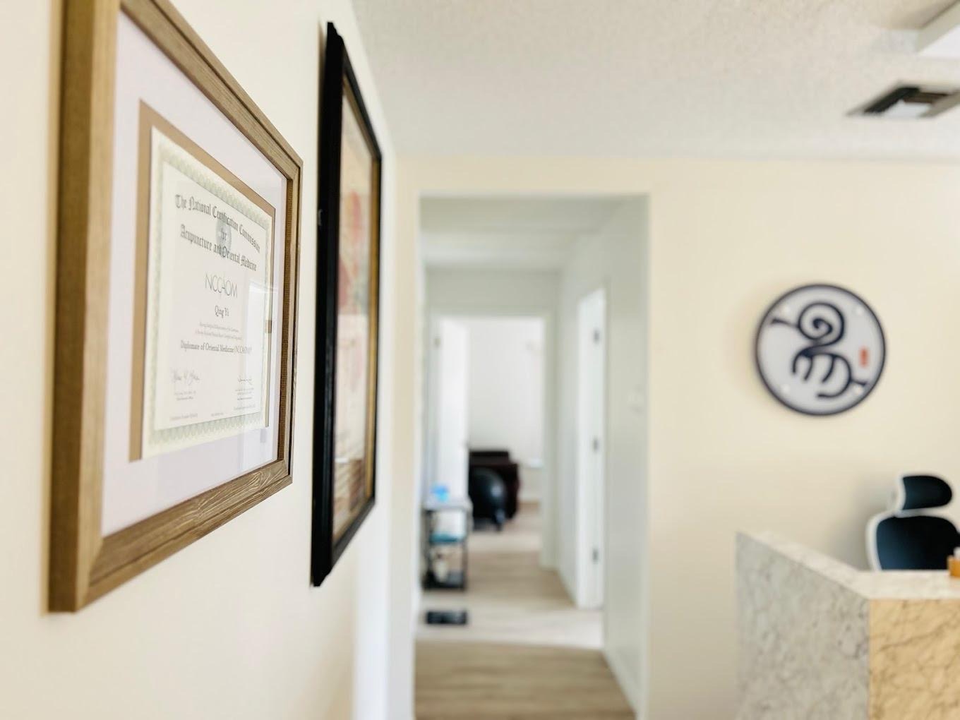 Yi Acupuncture clinic interior with company logo display