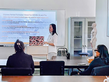 Dr. Yi teaching TCM and acupuncture techniques to community members